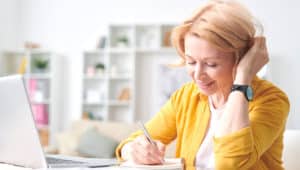 woman at desk yellow shirt